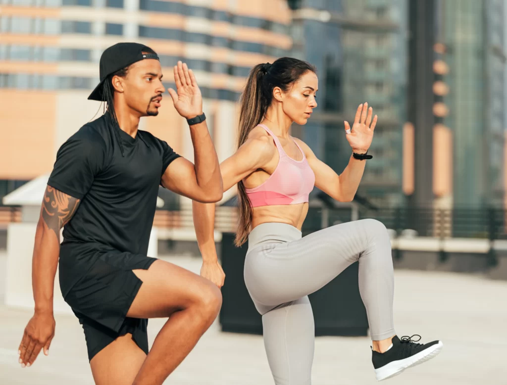 Couple stretching together on a park path